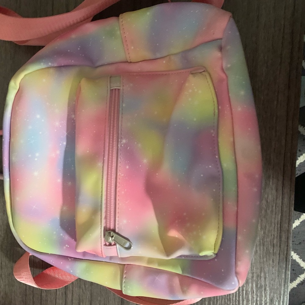 A pink rainbow color with a glitter sparkle mini bag.